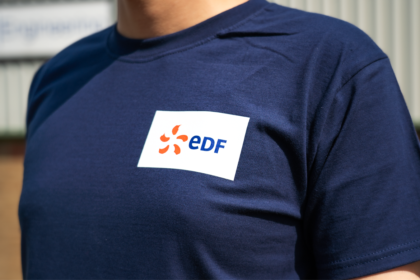 Person Wearing a T-Shirt with a logo on the chest