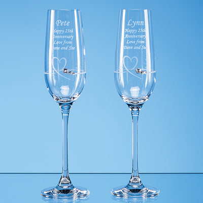 Pair of Champagne Flutes with heart shaped cut featuring Swarovski crystals bonded to the glass. With engraved message to loved ones.