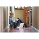 Woman sitting down writing with the Push button pen with black ink writing in a notebook