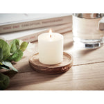 Candle on round wooden base